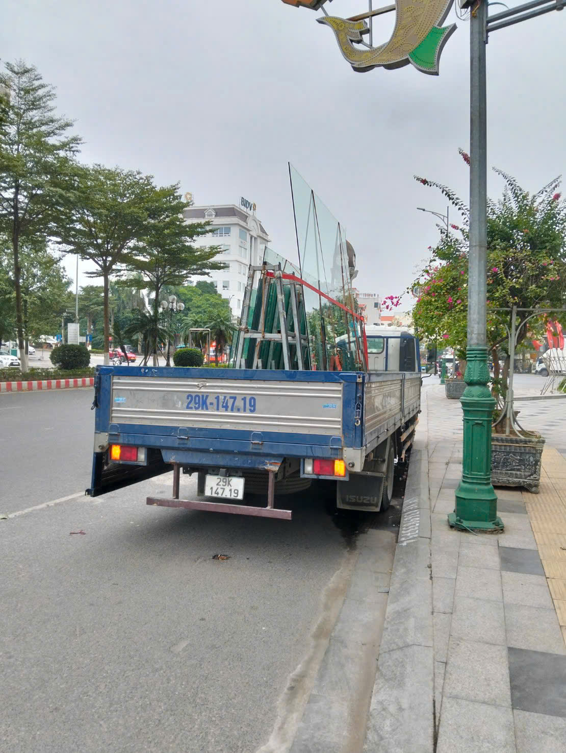 Xe tải chở các tấm kính đến công trình dưới ánh sáng ban ngày